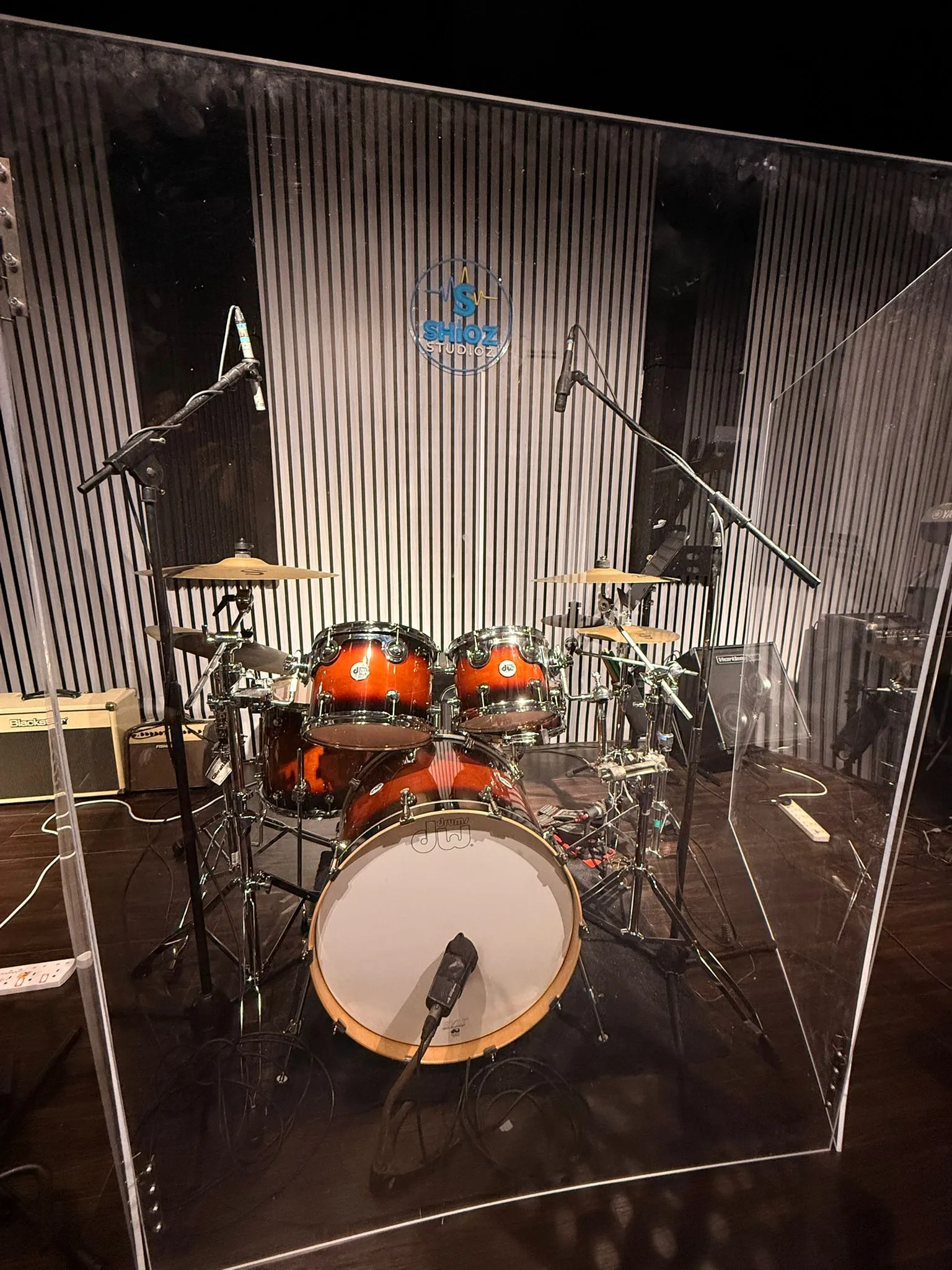 Drum kit inside a clear acoustic drum shield